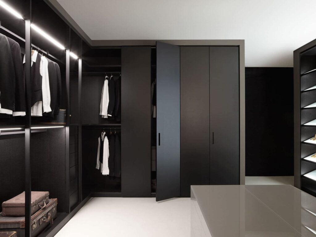 Luxury walk-in closet with black PVC cabinets and LED lighting by Evolux Cabinets, Brevard County, Florida.