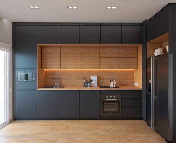 Modern indoor kitchen with matte black and natural wood finishes, custom waterproof PVC cabinetry by Evolux Cabinets.