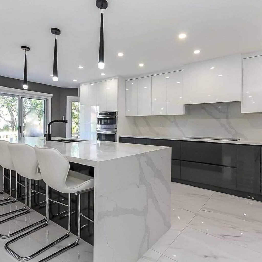 Modern waterproof PVC kitchen with marble-style island and glossy cabinets by Evolux Cabinets in Brevard County, Florida.