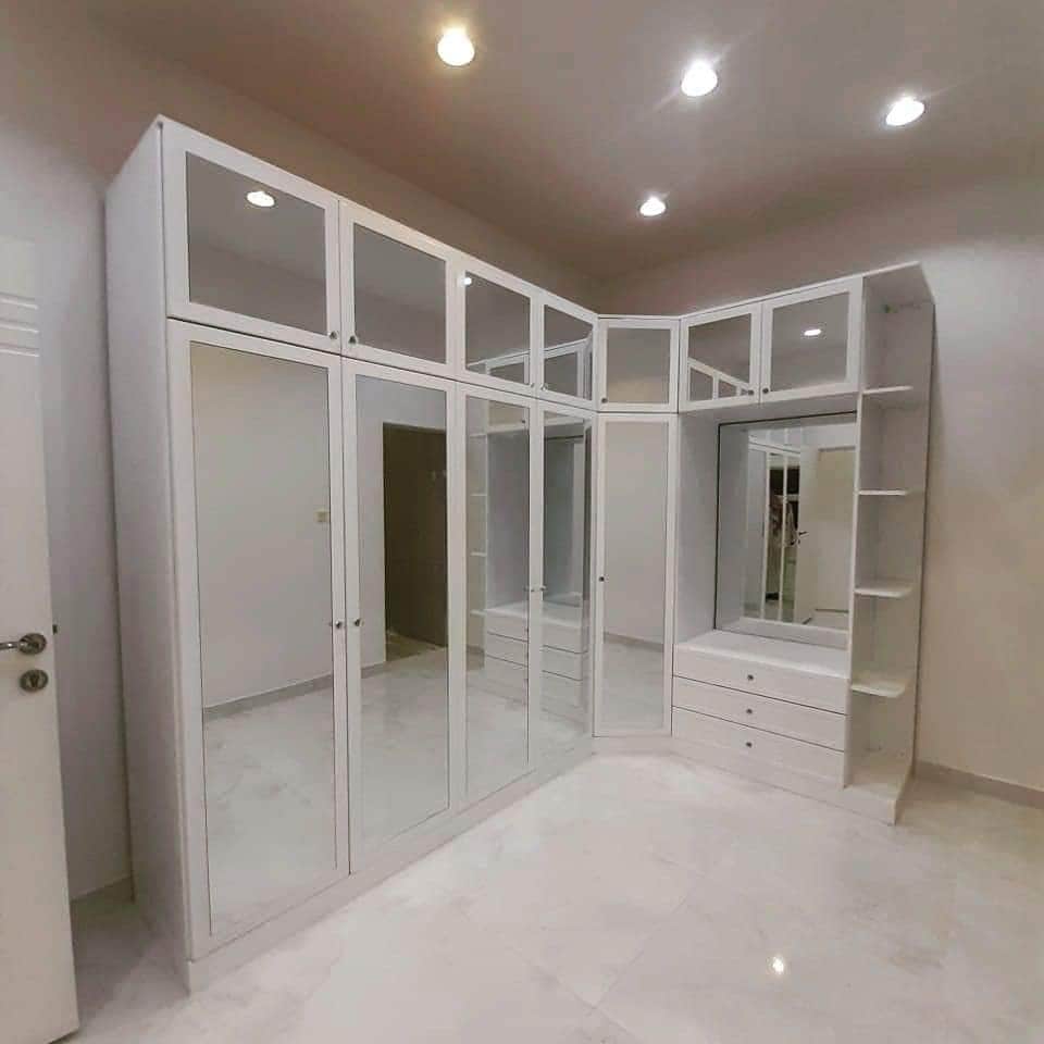 Corner mirrored waterproof PVC closet by Evolux Cabinets, modern design for homes in Brevard County, Florida.