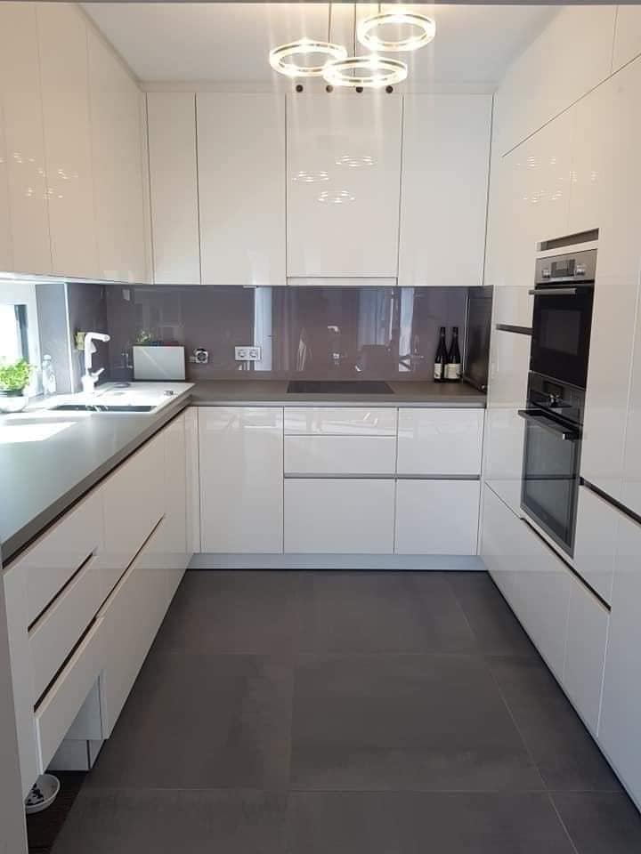 Modern white PVC kitchen cabinets with seamless design and waterproof finishes by Evolux Cabinets.