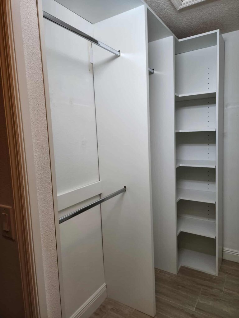 Custom white closet organizer with double hanging rods and adjustable shelves by Evolux Cabinets in Brevard County Florida.