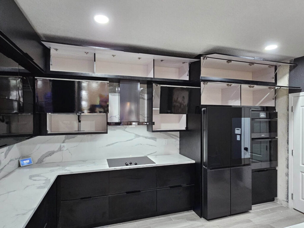Modern black waterproof PVC kitchen cabinets designed by Evolux Cabinets in Brevard County Florida with marble-style countertops.