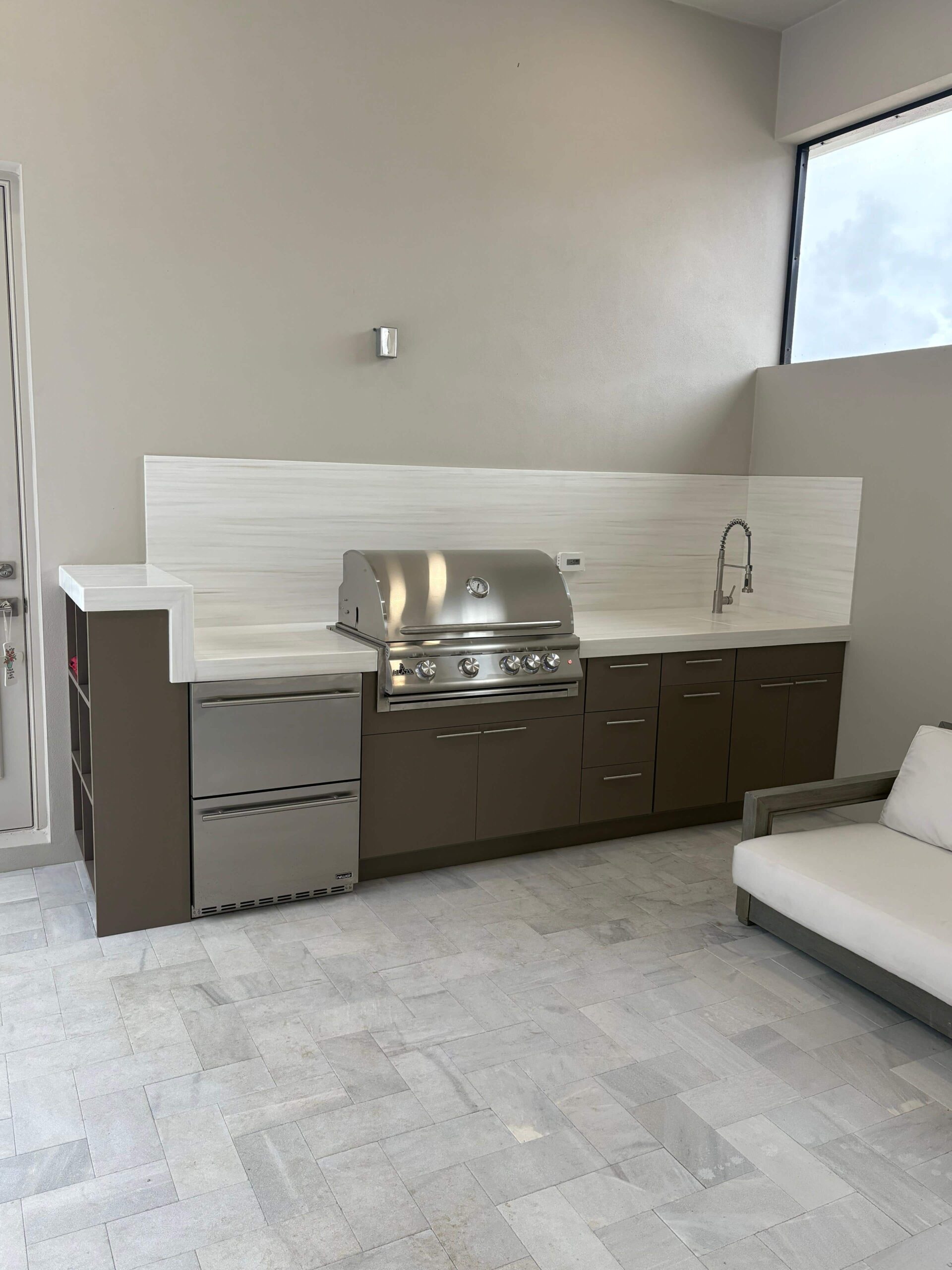 Outdoor kitchen with Durasing countertop and brown waterproof cabinets by Evolux Cabinets